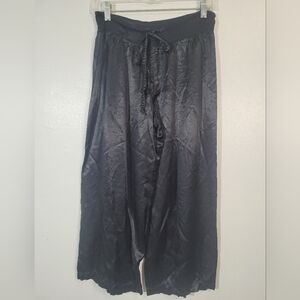 Black wide-leg trousers with a satin or silky finish. Size XS. Brand: PJ Harlow